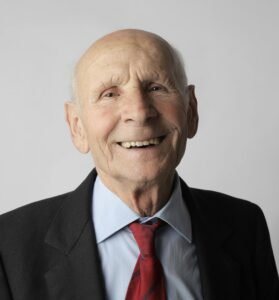 Portrait of a happy senior man in a suit. Ideal for lifestyle and senior care imagery.